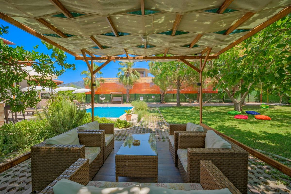 Aysel Villa verandasından havuz ve bahçe manzarası